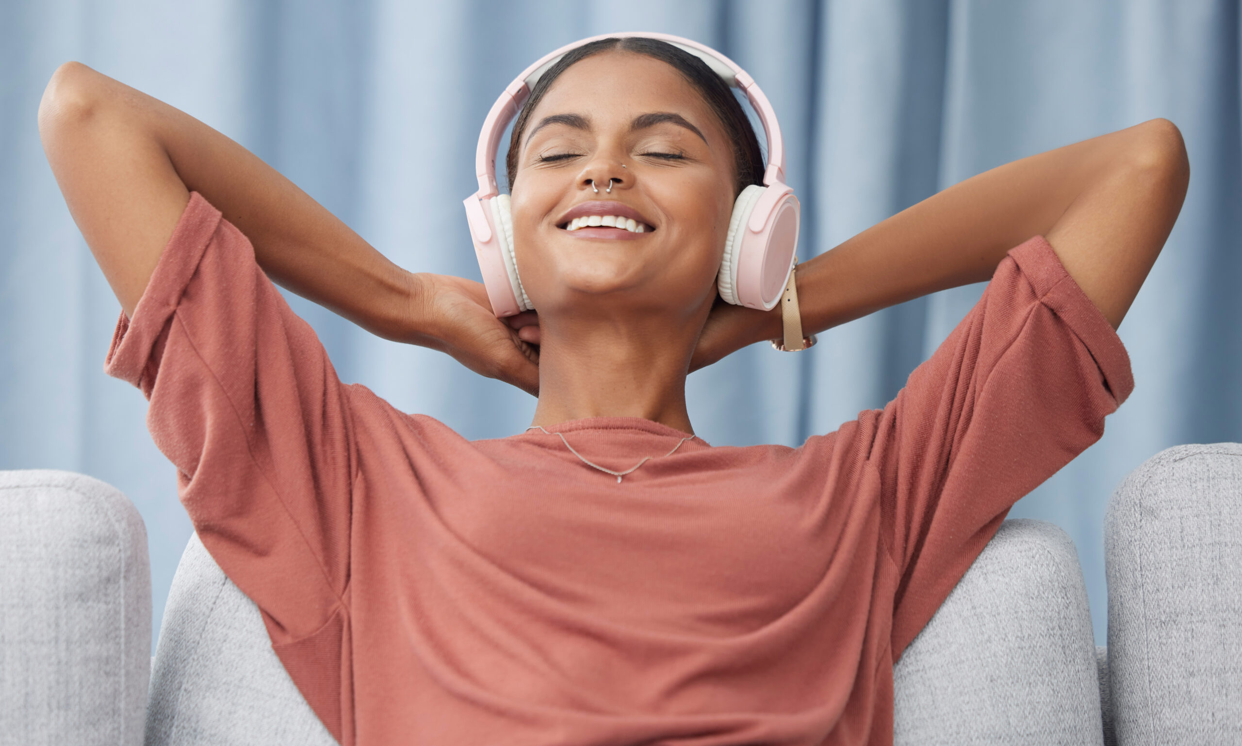 Relax, headphones and woman on a living room sofa feeling peace from music. Web radio, home and pod.