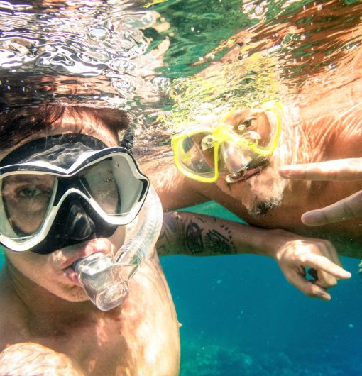 Adventurous best friends taking selfie snorkeling underwater - Adventure travel lifestyle enjoying happy fun moment - Trip together around Philippines wonders - Soft focus due to water density