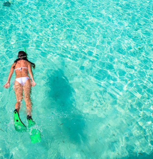 Woman snorkeling in tropical water on vacation